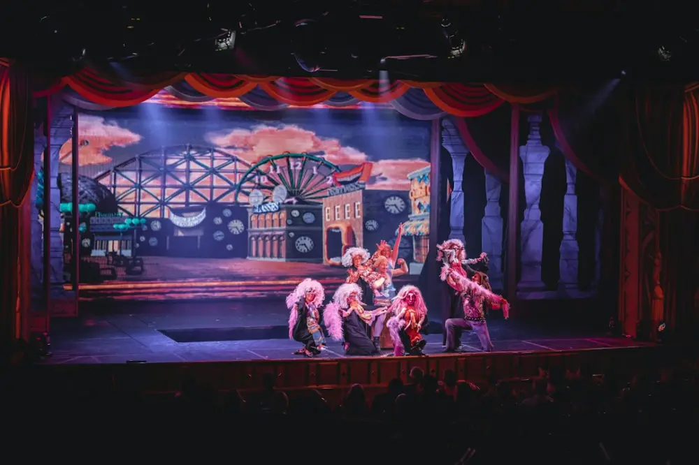 Crowd of people watching a stage performance in the theater, illustrating arts and narrative